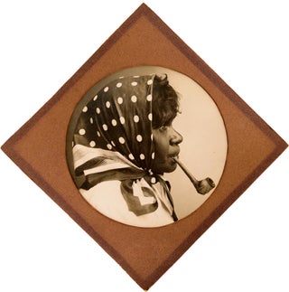 Item #100285 An imposing portrait photograph of a young Aboriginal woman smoking a pipe....