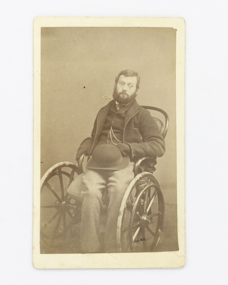 Item #102699 A carte de visite photograph of a relatively young man in a wheelchair. Portrait of a. Man in a. Wheelchair.