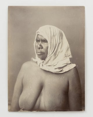 A fine portrait of an Indigenous Australian woman with traditional scarification, wearing a plain head-scarf knotted under her chin