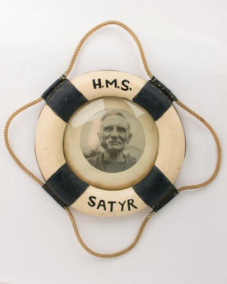 Item #110564 A portrait photograph of an old salt, framed in a small-format model of a life buoy...