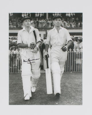 Item #114800 A signed photograph of Don Bradman walking out to bat with Jack Fingleton. Cricket,...