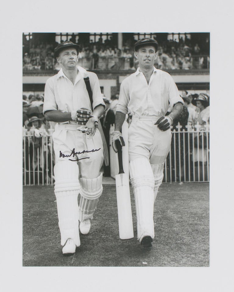 Item #114800 A signed photograph of Don Bradman walking out to bat with Jack Fingleton. Cricket, Don BRADMAN.