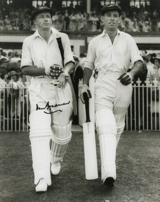 A signed photograph of Don Bradman walking out to bat with Jack Fingleton