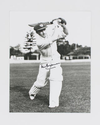 Item #114801 A signed photograph (black and white, 253 × 203 mm) of Don Bradman executing a...