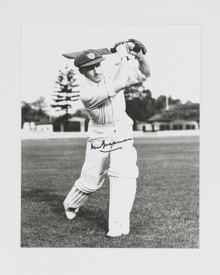 Item #114801 A signed photograph (black and white, 253 × 203 mm) of Don Bradman executing a straight drive. Cricket, Don BRADMAN.