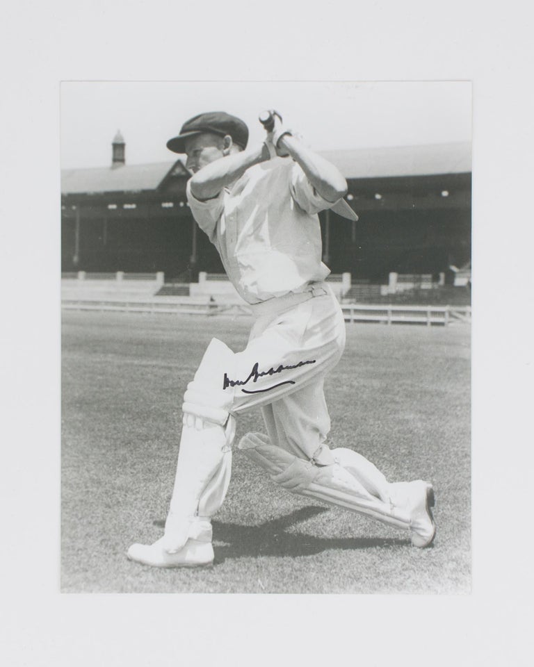 Item #114802 A signed photograph (black and white, 253 × 203 mm) of Don Bradman executing a cover drive. Cricket, Don BRADMAN.