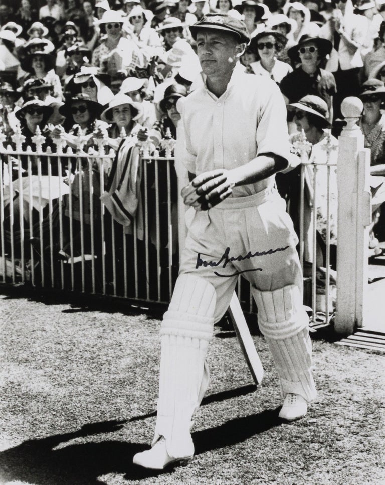 Item #114803 A signed photograph (black and white, 253 × 203 mm) of Don Bradman walking out to bat. Cricket, Don BRADMAN.