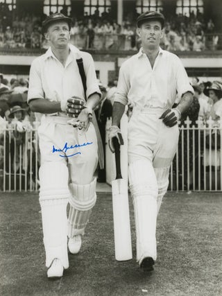Item #114804 An original signed photograph of Don Bradman walking out to bat with Jack Fingleton....