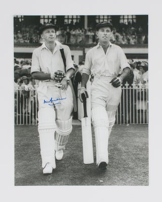 Item #114804 An original signed photograph of Don Bradman walking out to bat with Jack Fingleton....