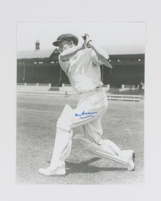 Item #114805 A signed photograph of Don Bradman executing a cover drive. Cricket, Don BRADMAN