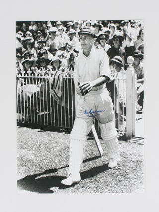 Item #114806 A signed photograph (black and white, 303 × 240 mm) of Don Bradman walking out to...