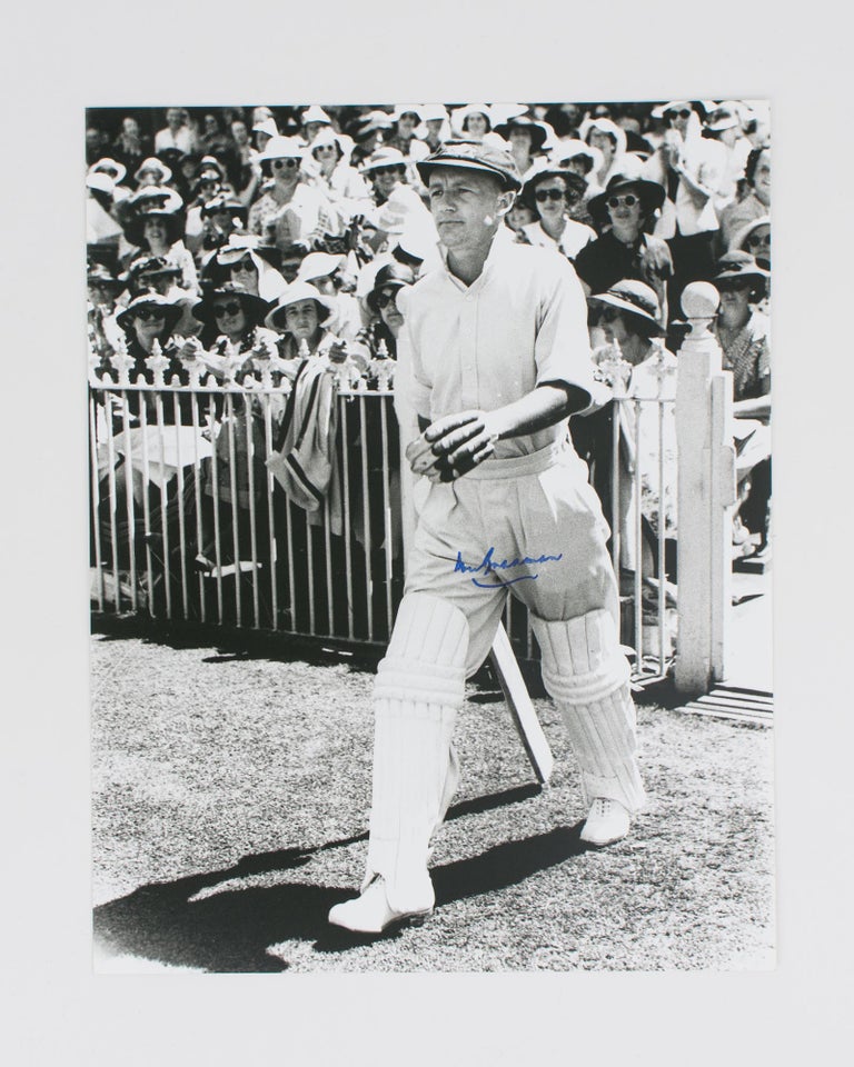 Item #114806 A signed photograph (black and white, 303 × 240 mm) of Don Bradman walking out to bat. Cricket, Don BRADMAN.