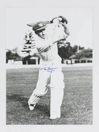 Item #114807 A signed photograph of Don Bradman executing a straight drive. Cricket, Don BRADMAN