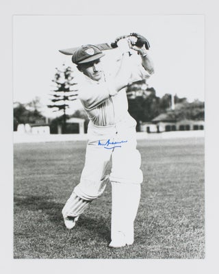 Item #114807 A signed photograph (303 × 240 mm) of Don Bradman executing a straight drive....