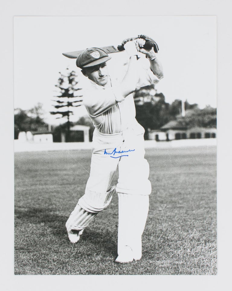 Item #114807 A signed photograph (303 × 240 mm) of Don Bradman executing a straight drive. Cricket, Don BRADMAN.