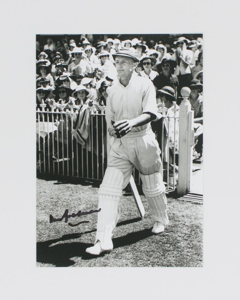 Item #114809 An original signed photograph of Don Bradman executing a cover drive. Cricket, Don BRADMAN.