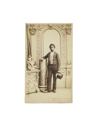 Item #114878 A carte de visite studio portrait of an African youth in livery, with top hat in...