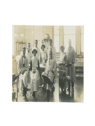 Item #114880 A vintage photograph of a hospital operating theatre, complete with nine doctors and...