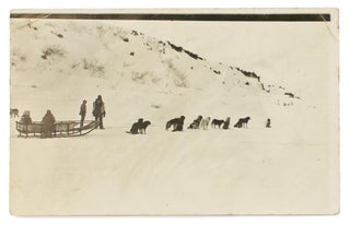 Item #115812 A postcard-format gelatin silver photograph of a dog-sled, with passengers and...