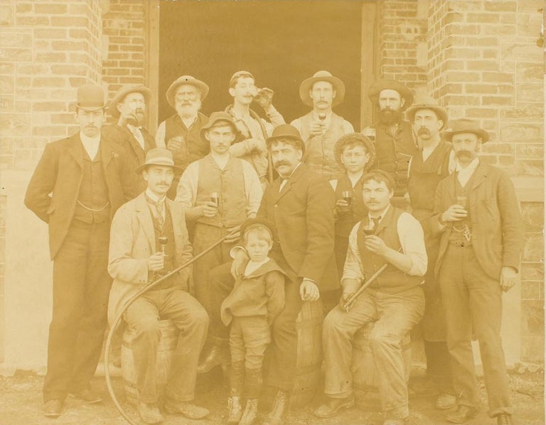 Item #115842 A vintage photograph of staff at Chateau Tanunda Winery in the Barossa Valley, South Australia; most of them are raising glasses of house wine, and those seated are on barrels. Barossa Valley.