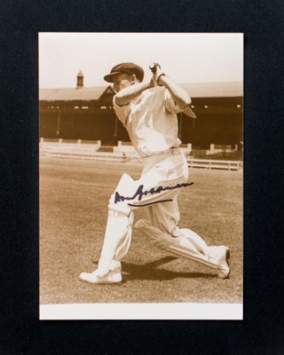 Item #118481 A signed photograph of Don Bradman executing a cover drive. Cricket, Don BRADMAN
