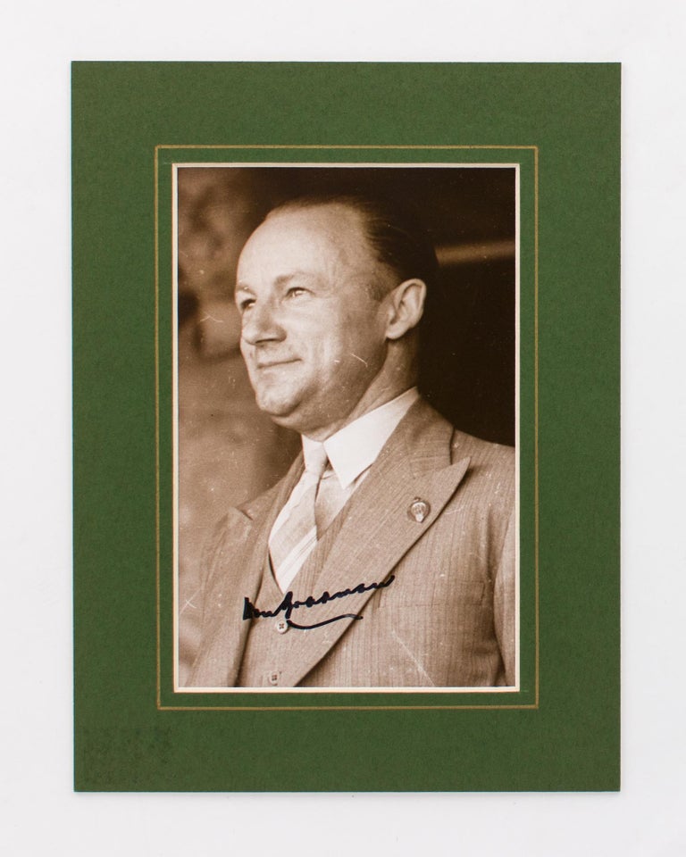 Item #118548 A signed portrait photograph of Don Bradman smartly attired in a three-piece business suit. Cricket, Don BRADMAN.