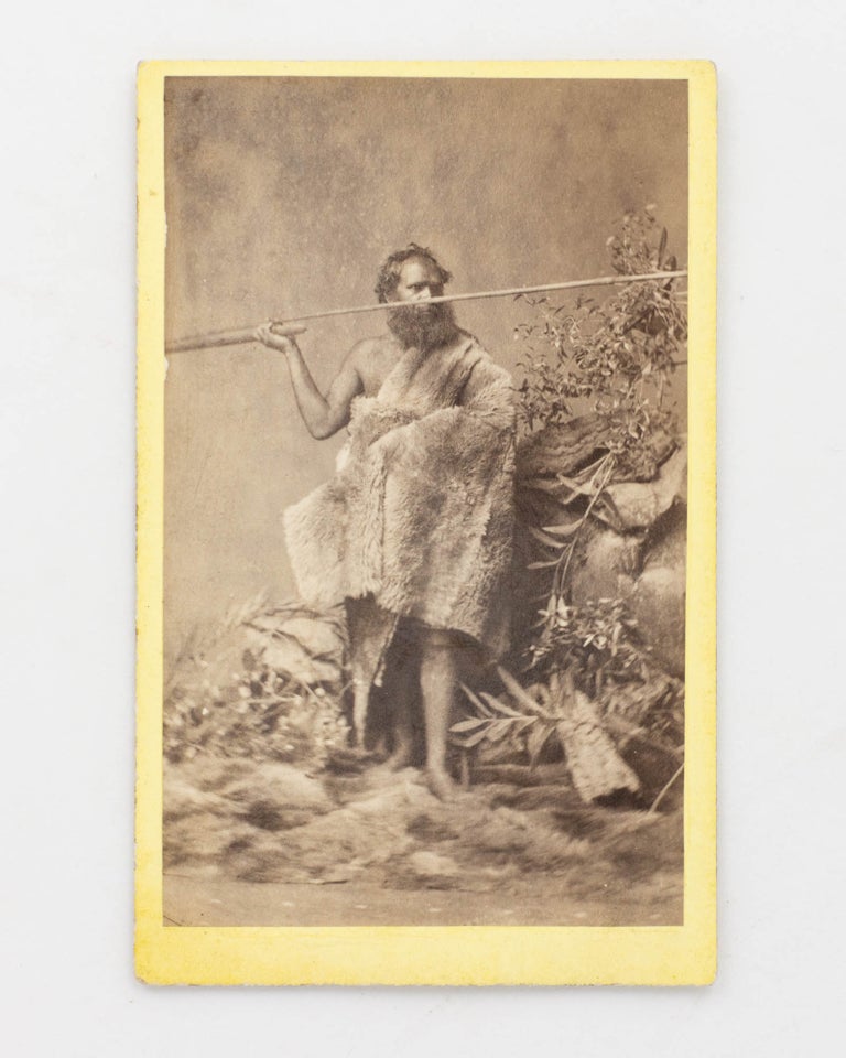 Item #123317 A carte de visite portrait photograph, a studio tableau of an Indigenous man wearing a fur cloak, holding a spear mounted in a woomera. Indigenous Australian Portraiture.
