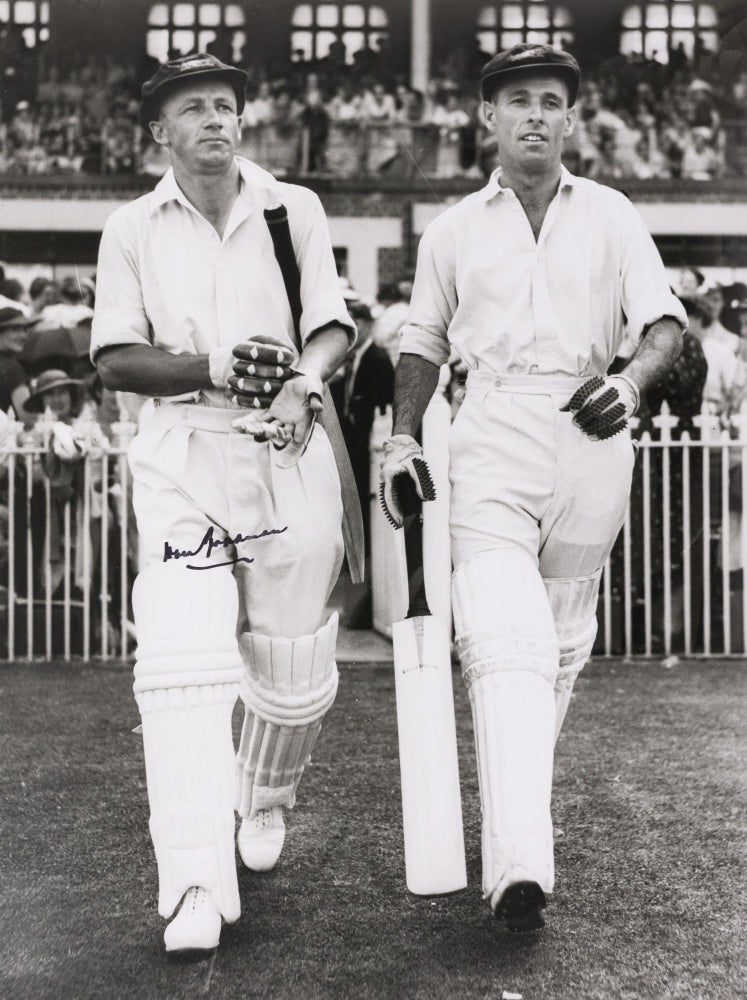 Item #129870 An original signed large-format photograph of Don Bradman walking out to bat with Jack Fingleton. Cricket, Don BRADMAN.