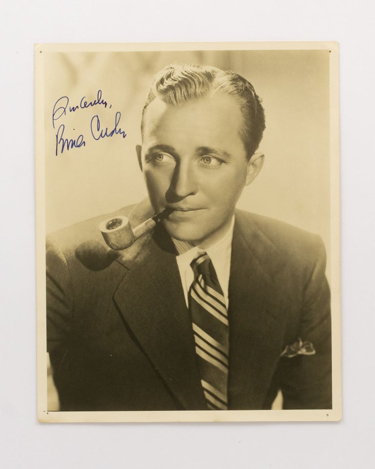 Item #134753 A signed portrait photograph of the popular and influential American singer and actor Bing Crosby (1903-1977) smoking a pipe. Bing CROSBY.