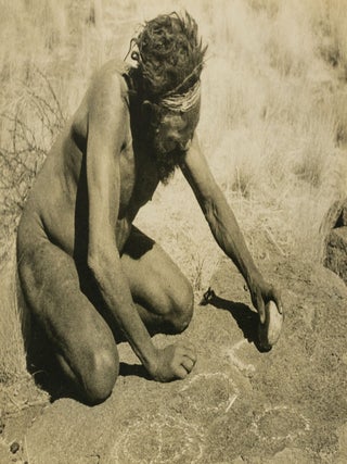 Item #144227 A vintage photograph of an Indigenous Australian man producing rock art near Mount...