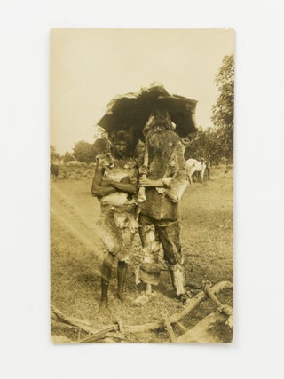 Item #147219 A vintage photograph of two men dressed in costumes fashioned from animal skins...