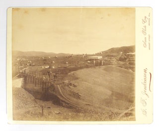 Four large albumen paper photographs of the Broken Hill region. The photographs, each approximately 200 × 225 mm, are on the original glossy cream-coloured mounts with the imprint of the photographer, 'G.F. Jenkinson, Areas Photo Coy, Argent Street, Broken Hill'