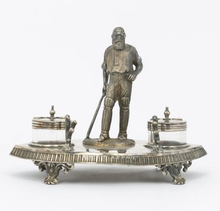 A silver-plated standish - a desk set holding pens and ink - featuring a 120 mm-high figure of W.G. Grace as its centrepiece