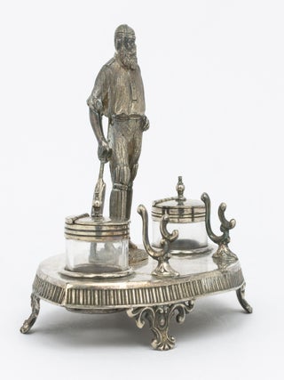 A silver-plated standish - a desk set holding pens and ink - featuring a 120 mm-high figure of W.G. Grace as its centrepiece