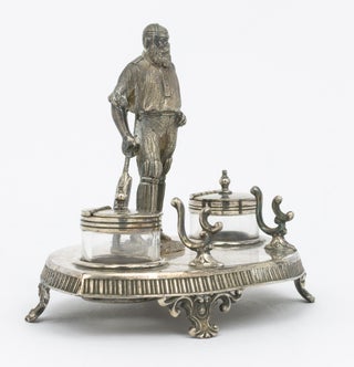 A silver-plated standish - a desk set holding pens and ink - featuring a 120 mm-high figure of W.G. Grace as its centrepiece