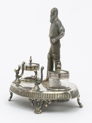 A silver-plated standish - a desk set holding pens and ink - featuring a 120 mm-high figure of W.G. Grace as its centrepiece