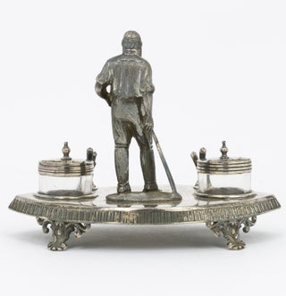 A silver-plated standish - a desk set holding pens and ink - featuring a 120 mm-high figure of W.G. Grace as its centrepiece