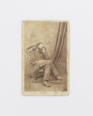 A carte de visite self-portrait, depicting the photographer 'dozing' peacefully in a high-backed padded armchair